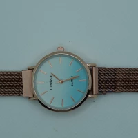 OROLOGIO CON CINGHIA IN ACCIAIO ROSA CON CALAMITA E QUADRANTE AZZURRO